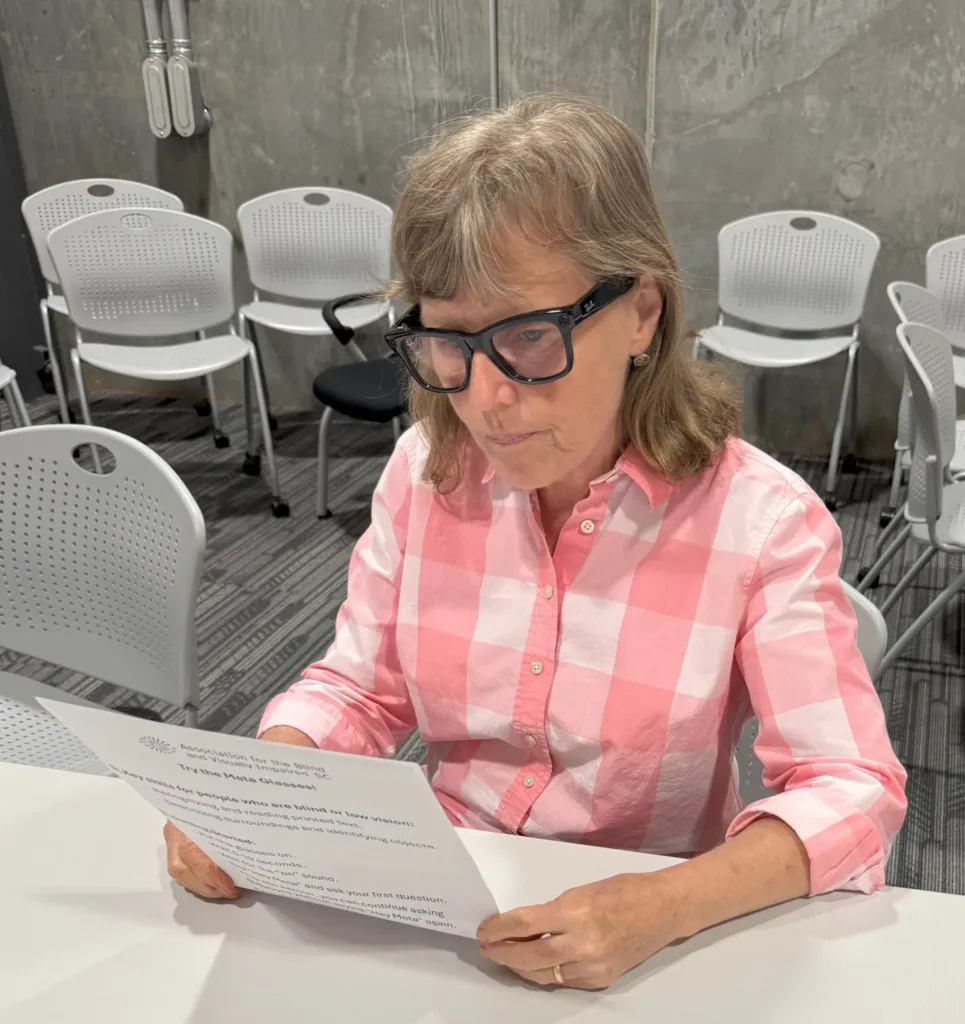 A woman wearing meta glasses reading a printed document.