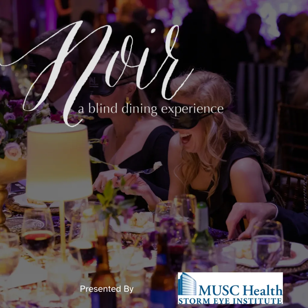 Picture of a gala event with diners wearing eye masks enjoying their meal.