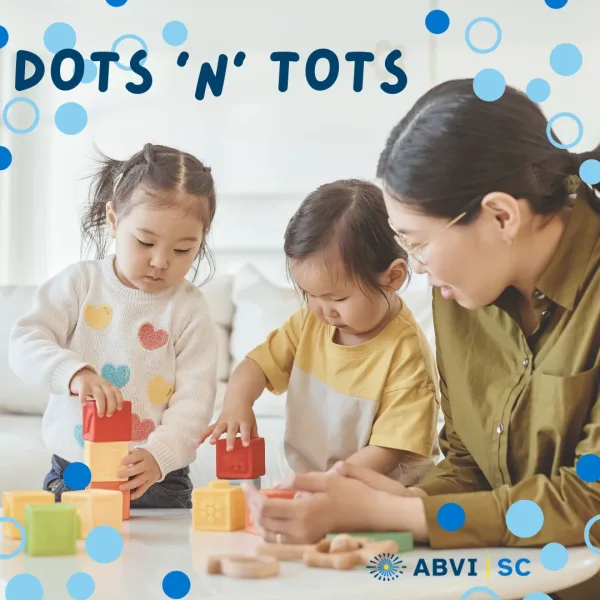 Dots Tots Fine Motor Title of Image reads "Dots 'N' Tots" in blue text on a background photo of a woman playing blocks with two toddler girls.