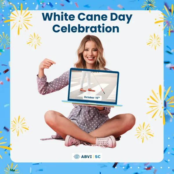 Young adult woman sits cross legged, pointing to a laptop she's holding. The laptop screen displays someone using a white cane. Text reads White Cane Day Celebration.